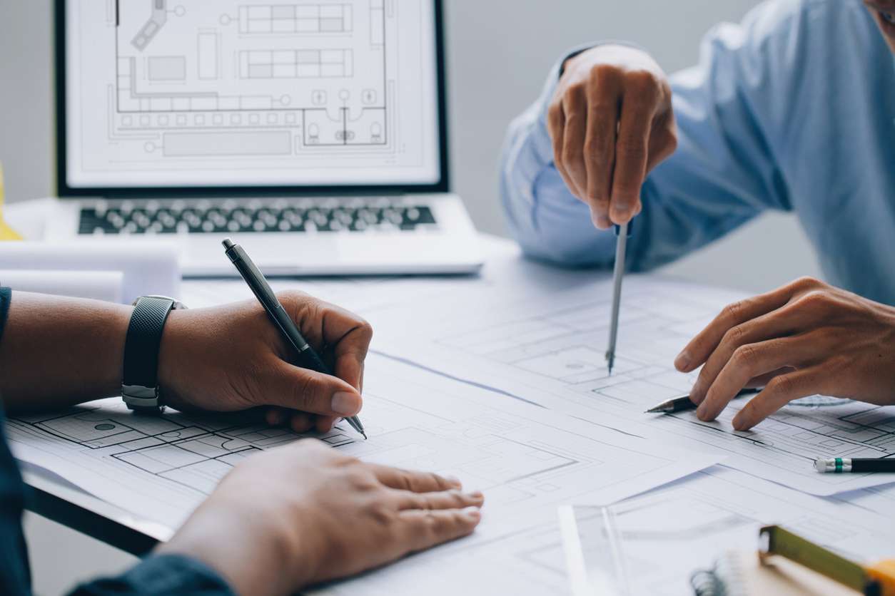 Two people working on a project on a desk