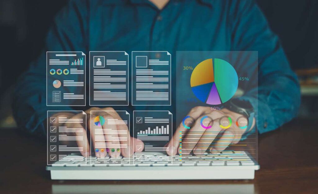 Man typing on a keyboard with an overlaying image of virtual documents, graphs, and pie charts