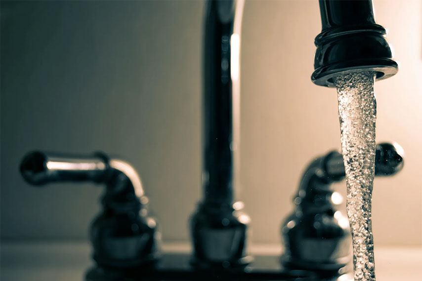 Close-up of a faucet with water coming out of it